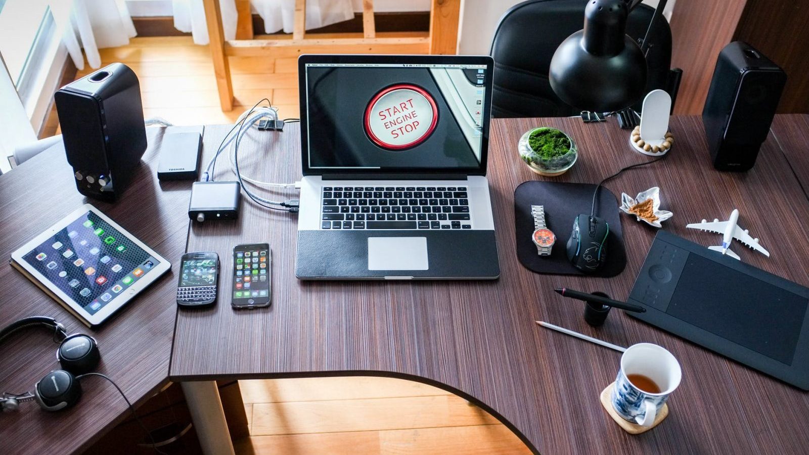 black and white laptop computer on brown wooden desk